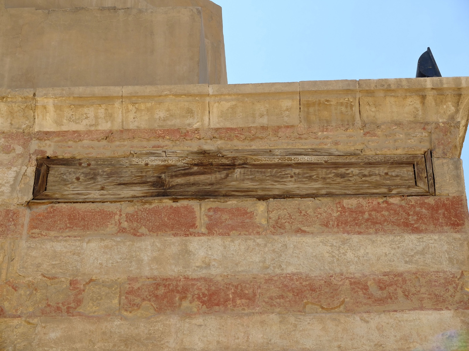 Faded Arabic inscription painted on a wooden panel at the fountain dome of the Ibn Tulun Mosque in Cairo